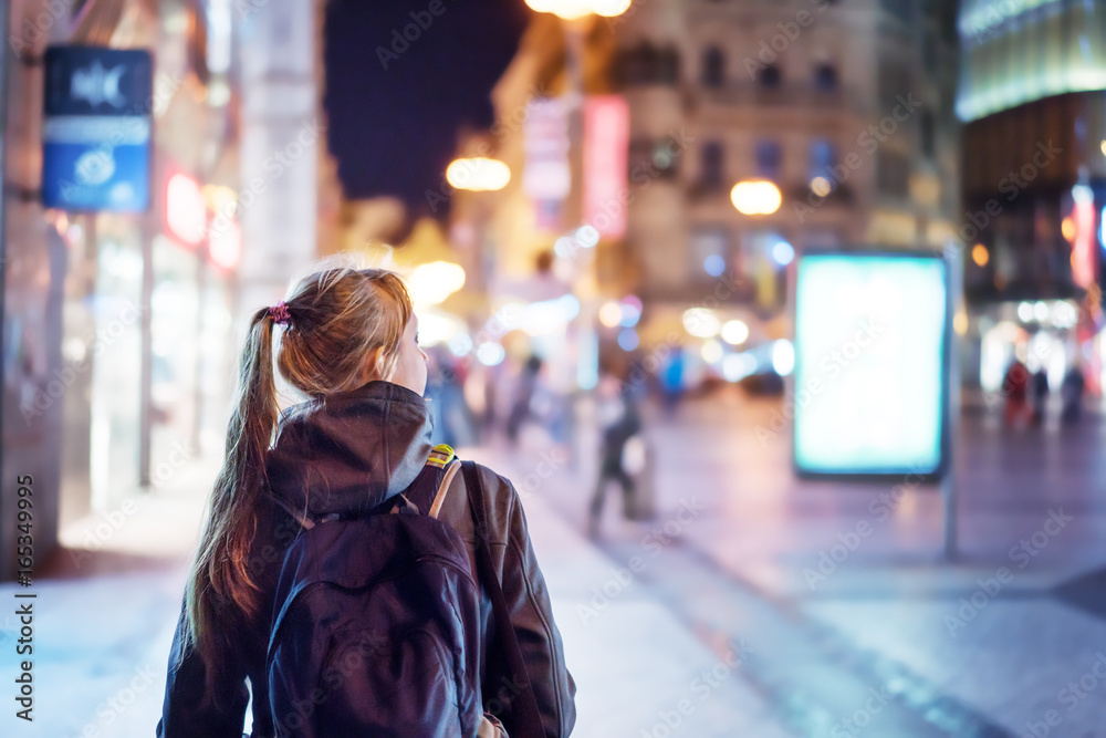 Back view of girl walking on city street at night, Prague Stock Photo ...