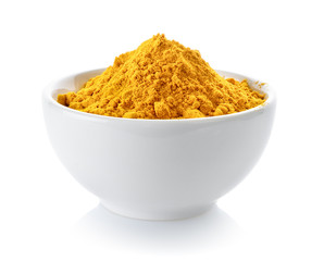 Wall Mural - Turmeric powder in a bowl on white background