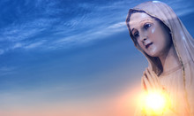 Statue Of The Virgin Mary Against Sunrise