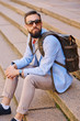 Urban traveller bearded man with a backpack.