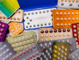 Wall Mural - Piles of colorful birth control pills with modern packaging