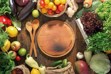 Around round kitchen board set of fresh vegetables and fruits