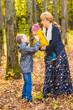 © satura_ - Family, nature, autumn and people concept - Portrait of Happy mother, son and baby in fall