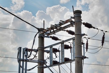 Wall Mural - Pillar of power line in the sky with clouds. Summer weather. Energy industry.