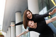 © shurkin_son - Happy Caucasian couple having fun outdoors. Bearded attractive young male giving a piggyback ride to his cheerful excited cute girlfriend, both keeping arms stretched posing in urban setting