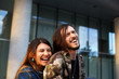 © shurkin_son - Happy cheerful young Caucasian man and woman enjoying nice time together, laughing, having fun while walking on city streets on warm sunny day. People, relationships and modern lifestyle concept