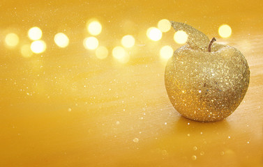 Wall Mural - Rosh hashanah (jewish New Year holiday) concept. Decorative gold glitter apple