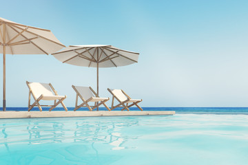 Wall Mural - Swimming pool, deck chairs, umbrellas, horizon