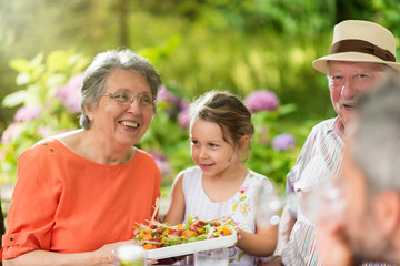 Sticker - Three generations family having lunch in the garden