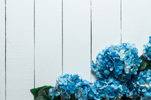 Blue Hydrangea Flowers On A White Wooden Texture Background.Artificial Flowers