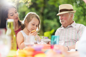 Poster - Three generations family  picnic in the garden