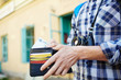 © pressmaster - Closeup image of young tourist putting money in wallet