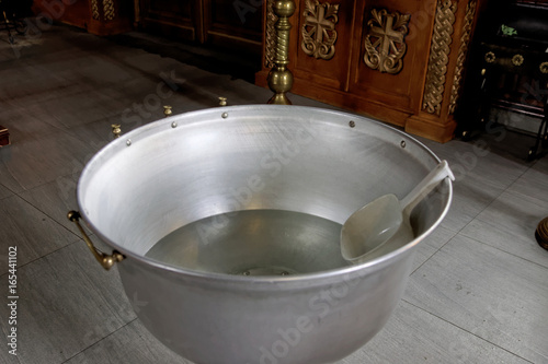 Fotografia, Obraz The baptism of a child in the Orthodox Church. Chan for ablution.