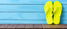 Green Flip Flops On Wooden Background. Close Up