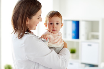 Canvas Print - happy doctor or pediatrician with baby at clinic