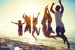 © alphaspirit - Happy smiling friends jumping at the beach