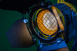 A spotlight with a Fresnel lens and a halogen lamp. Equipment for photographing and filming in the interior. Close-up.