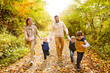 © Halfpoint - Beautiful young family on a walk in autumn forest.