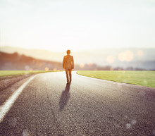 Man Walks On An Unknown Road For A New Adventure