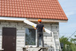 © kuchina - builder works on the roof