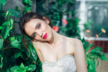 Closeup portrait of young beautiful pretty cute girl in evening dress posing  and looking at you. Fashion photo. bride