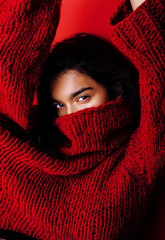 young pretty indian girl in red sweater posing emotional, fashion hipster teenage, lifestyle people concept