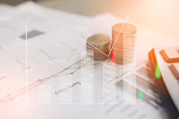 Calculator and coin,money with business graphs and charts report on table, calculator on desk of financial planing. Financial concepts.