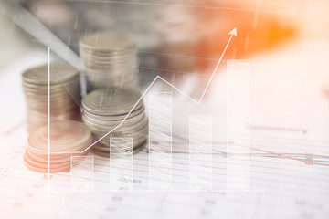 Calculator and coin,money with business graphs and charts report on table, calculator on desk of financial planing. Financial concepts.