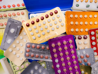 Wall Mural - Piles of colorful birth control pills with modern packaging