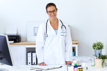 Confident female doctor in the office looking at camera.