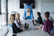 © .shock - boss dresed as bear having fun with business people in trendy office