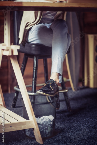 Close Up View Of Mans Legs On High Chair Under The Table