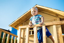 A Boy On The Playground. Children Wooden House
