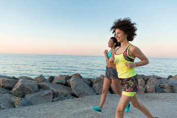 Wall Mural - Happy smiling fitness women jogging together