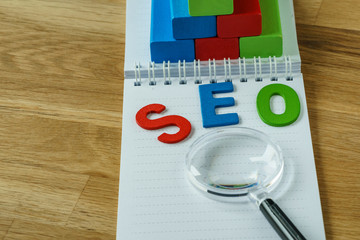 Aufkleber - seo search engine optimization concept as colorful alphabet abbreviation seo on magnifying glass on 