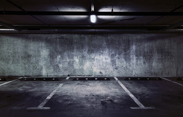 Urban underground background. Concrete wall under the lamp light in the dark.