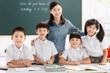 © View Stock - Portrait of smiling student and teacher standing in classroom