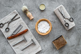 Fototapeta Sypialnia - Accessories for shaving. Shaving brush, razor, foam, sciccors on grey stone table background top view