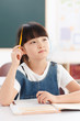 © View Stock - Girl sitting at desk in classroom