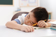 © View Stock - Tired school boy having rest in classroom