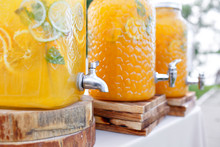 Jar of tasty fresh orange lemonade with ice and mint.