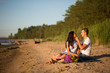 © viktoria_koks - A young couple in love, on the shore of the Bay at sunset