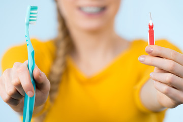 Woman smiling cleaning teeth with braces