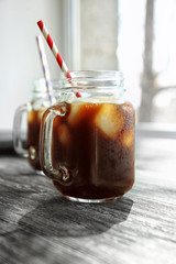 Poster - Mason jar with cold brew coffee and straw on wooden table