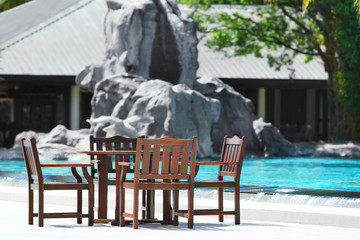 Wall Mural - Table and chairs of beach cafe at resort. Summer vacation concept