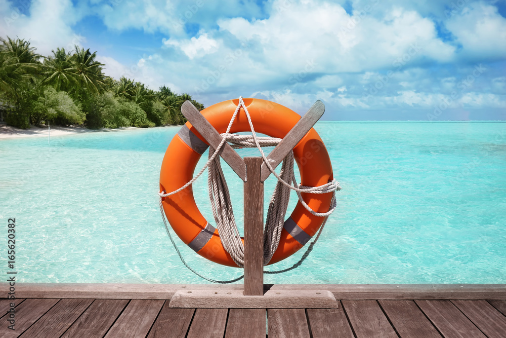 Wooden pontoon with flotation ring at sea resort