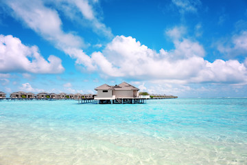 Canvas Print - Modern beach houses on piles at tropical resort