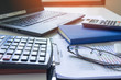 © KPs Photography  - Calculator with business graphs and charts report on tabble, calculator on desk of financial planing. Financial concepts.