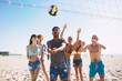 © alphaspirit - Group of friends playing at beach volley at the beach