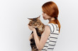 © SHOTPRIME STUDIO - Beautiful young woman on white isolated background holds a cat
